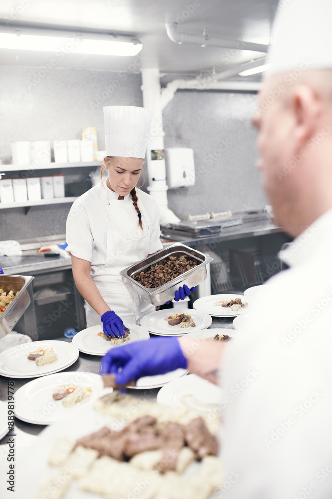 Food, teamwork and chef in kitchen for fine dining, catering service or nutrition dish. Hospitality, professional and coworker people for cooking meal, preparation or dinner rush in restaurant Food, teamwork and chef in kitchen for fine dining, catering service or nutrition dish. Hospitality, professional and coworker people for cooking meal, preparation or dinner rush in restaurant