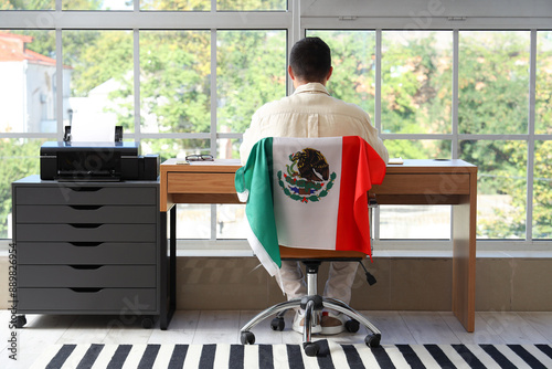 Young man with Mexican flag...