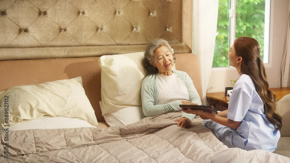 Asian woman doctor examine and consult senior patient on the bed in bedroom. Private duty nurse visit and take care elderly woman at home. Home medical caregiving service and health insurance concept. Asian woman doctor examine and consult senior patient on the bed in bedroom. Private duty nurse visit and take care elderly woman at home. Home medical caregiving service and health insurance concept.