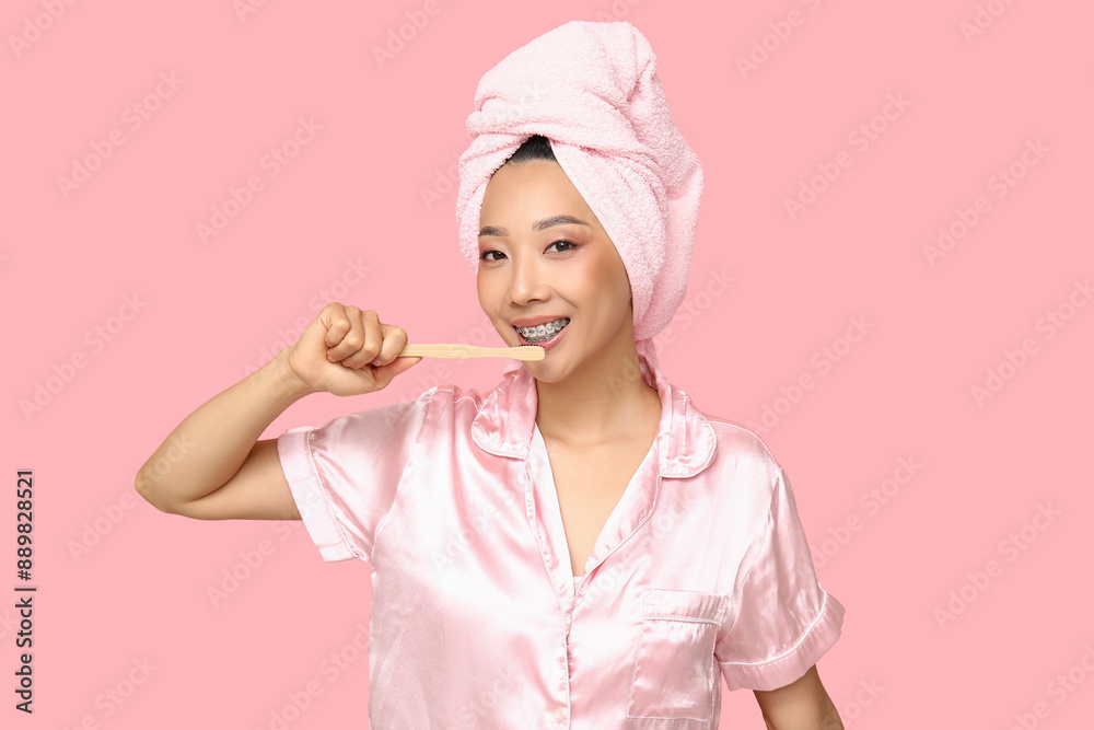 Young Asian woman on pink background