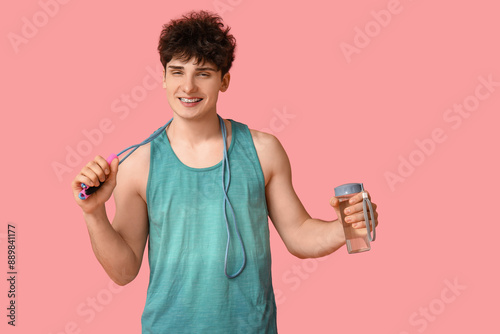 Sporty guy with bottle of w...