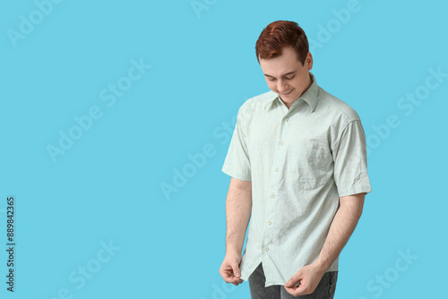 Fotografie Handsome young man in stylish collar shirt on blue background
