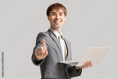 Young businessman with lapt...