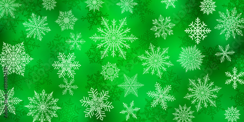 Christmas background of beautiful complex snowflakes, white on green. Winter illustration with falling snow.