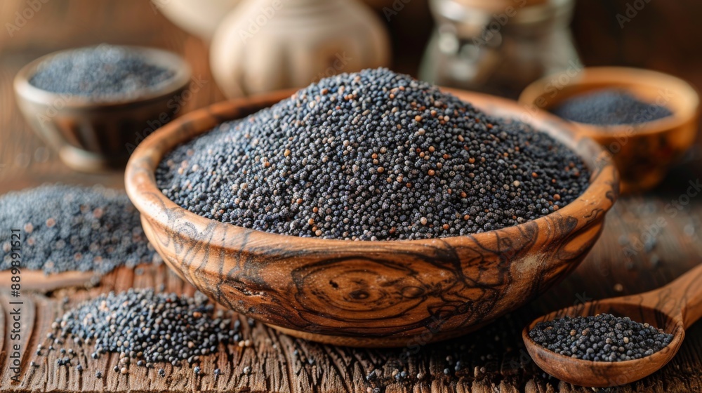 Poppy seeds in small wooden bowl on dark table. Poppies head on board with backlight. Poppy seeds in small wooden bowl on dark table. Poppies head on board with backlight.