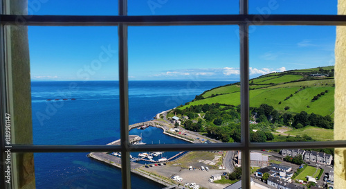 Looking through a window of the beautiful Glenarm Village on the Irish Sea Antrim Northern Ireland on a sunny day with a blue sky photo