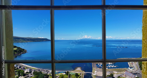 Looking through a window of the beautiful Glenarm Village on the Irish Sea Antrim Northern Ireland on a sunny day with a blue sky photo