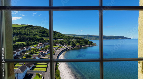 Looking through a window of the beautiful Glenarm Village on the Irish Sea Co Antrim Northern Ireland on a sunny day with a blue sky photo