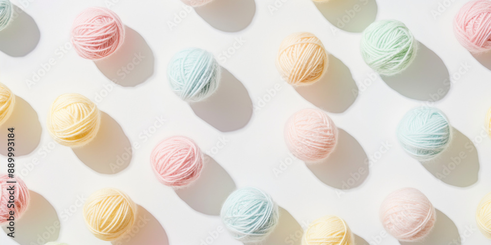 A background of pastel-colored wool yarn balls, each with its shadow, scattered across the canvas in an elegant display, with soft shadows on a white background A background of pastel-colored wool yarn balls, each with its shadow, scattered across the canvas in an elegant display, with soft shadows on a white background