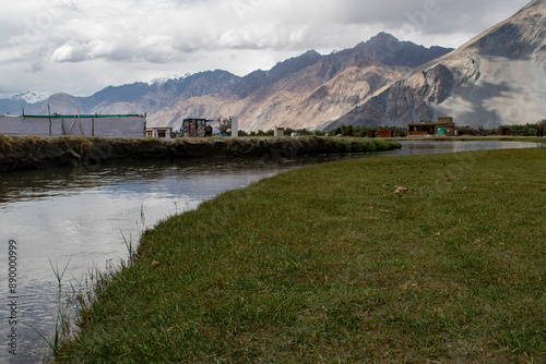 the river with blue sky and sandstone mountains in nubra valley, leh ladakh, india