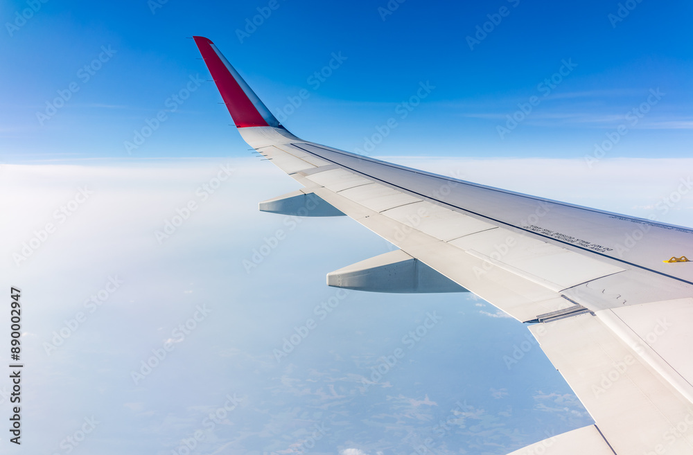 View from the airplane window at a beautiful cloudy sky and the airplane wing View from the airplane window at a beautiful cloudy sky and the airplane wing