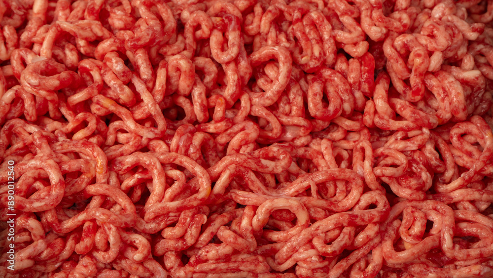Raw chopped meat as a background. Top view. Raw chopped meat as a background. Top view.