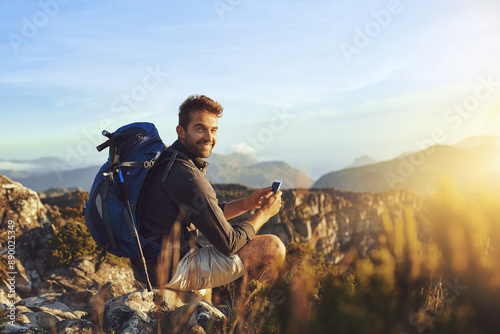Portrait, hiking and man on mountain with cellphone for geology career with digital nomad for travel. Nature, backpack and petrologist trekking with phone for environmental research in Australia.
