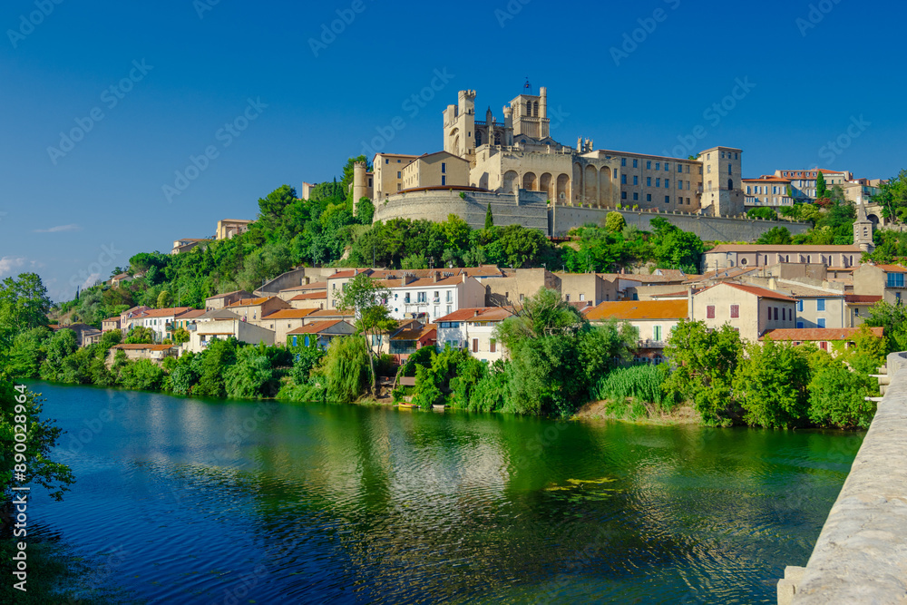 Cathedral Saint-Nazaire-A river runs through a town with a castle in the background Cathedral Saint-Nazaire-A river runs through a town with a castle in the background
