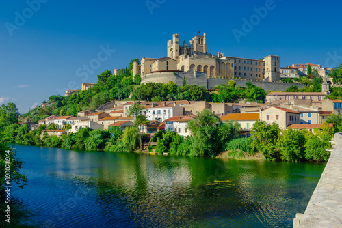 Cathedral Saint-Nazaire-A river runs through a town with a castle in the background photo