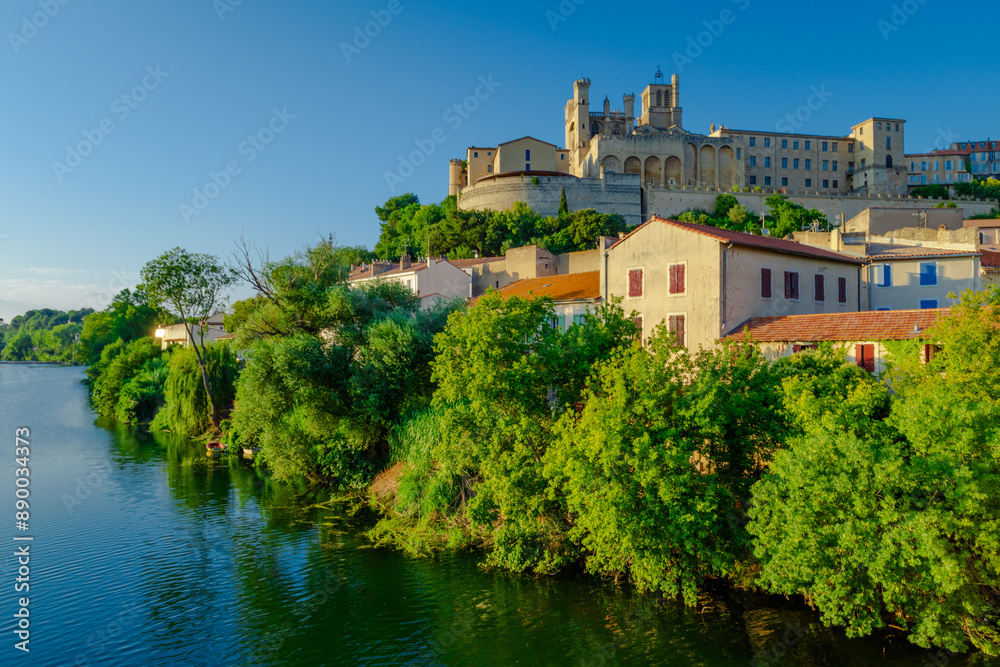 Cathedral Saint-Nazaire-A river runs through a town with a castle in the background Cathedral Saint-Nazaire-A river runs through a town with a castle in the background