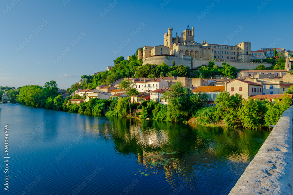 Cathedral Saint-Nazaire-A river runs through a town with a castle in the background Cathedral Saint-Nazaire-A river runs through a town with a castle in the background