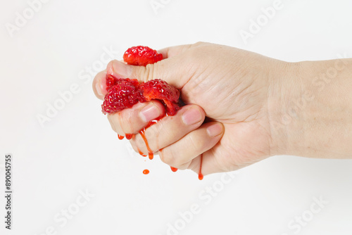 Holding strawberries with one hand on white background