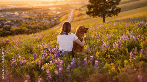 Girl and her dog in a golden field of wildflowers at sunset