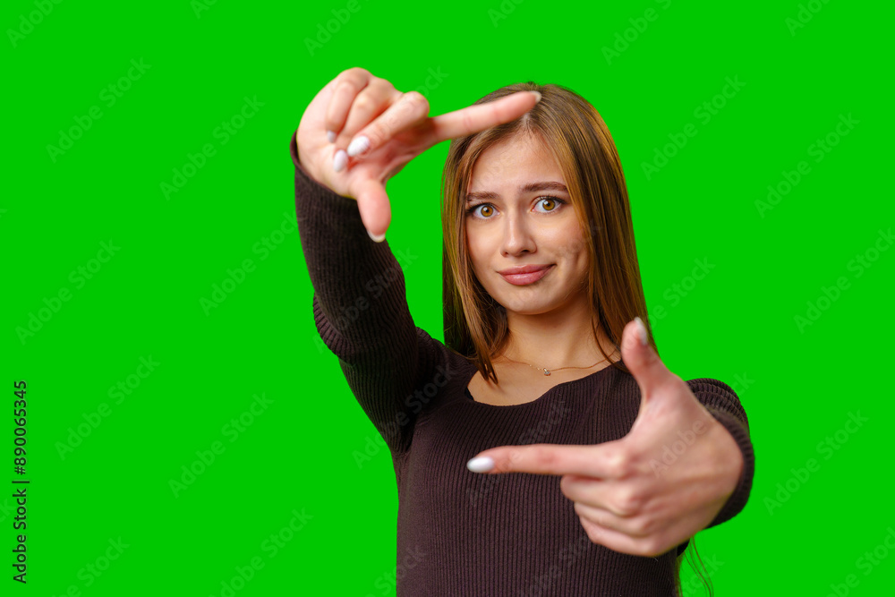 Fototapeta premium Woman Framing With Fingers On Green Screen