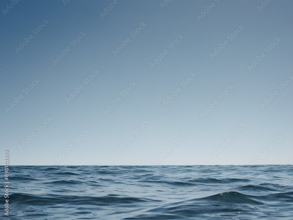 Obraz premium Calm ocean waves with a blue sky background