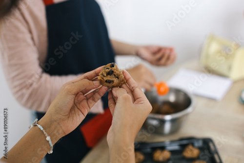 Selective Focus Of Hands Showing Cookies Dough Topped With Chocolate Chips