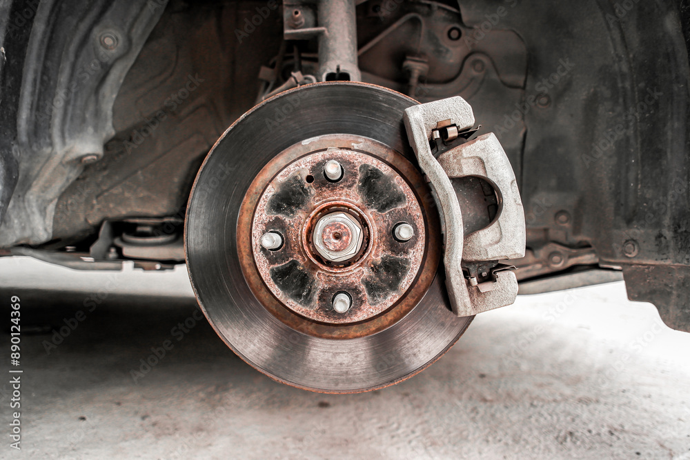 Old brake rotor and caliper with brake pad in a suspension of car , Automotive parts concept Old brake rotor and caliper with brake pad in a suspension of car , Automotive parts concept