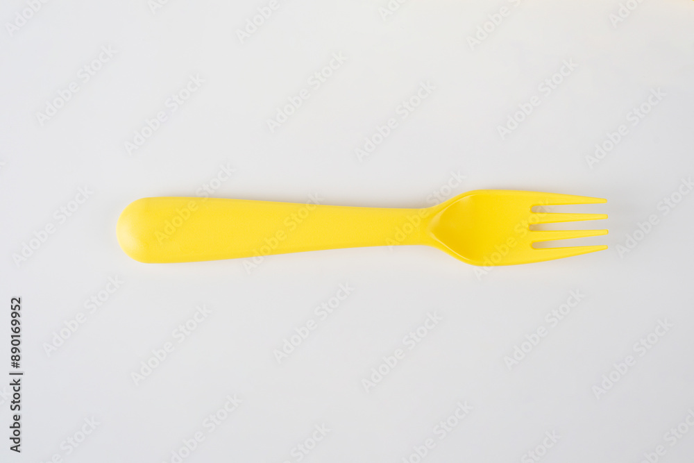 Yellow fork and spoon isolated on white background. Yellow fork and spoon isolated on white background.