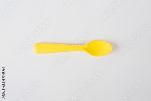 Yellow spoon isolated on white background.