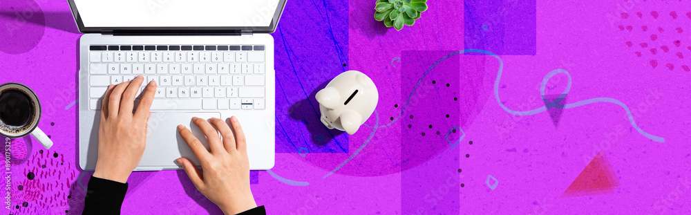 Laptop computer with piggy bank - flat lay