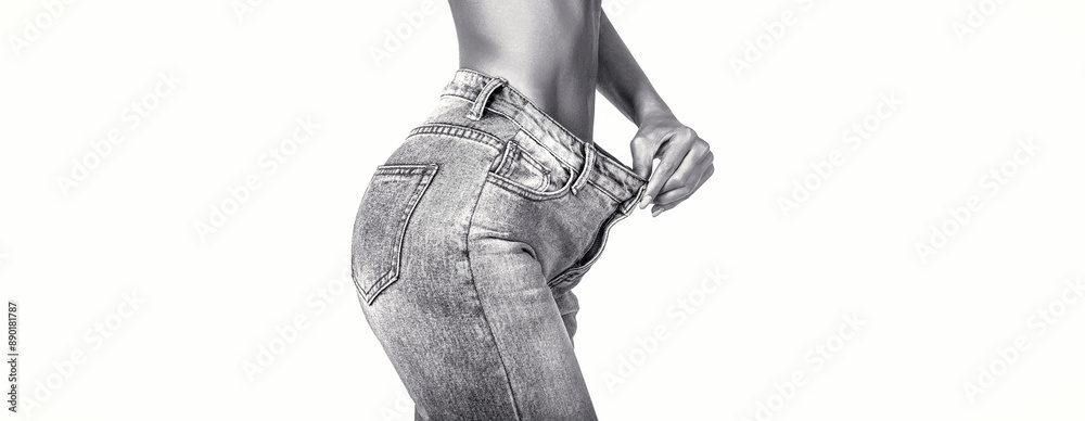 © Yevhen - The concept of diet and weight loss. Woman in big jeans on white background. Weight loss concept. Thin woman in big pants, weight loss concepts. Black and white.