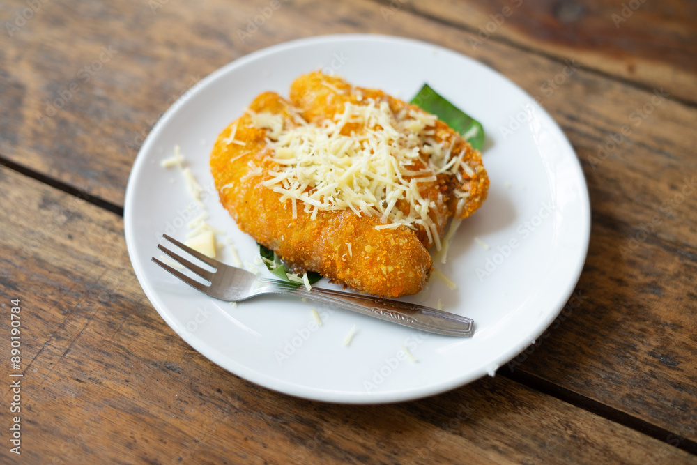 Crispy fried bananas topped with cheese, highlighting a delicious and indulgent treat, perfect for food, dessert, and culinary Crispy fried bananas topped with cheese, highlighting a delicious and indulgent treat, perfect for food, dessert, and culinary