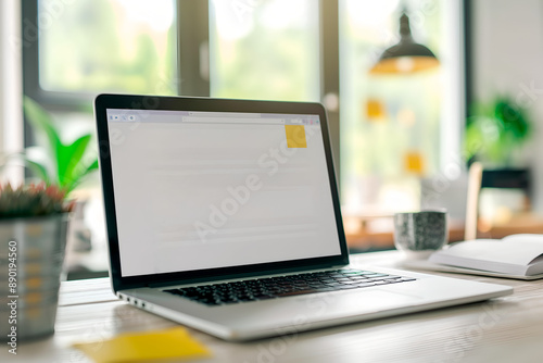 Open Laptop on Desk with Plants, Bright Home Office Setting