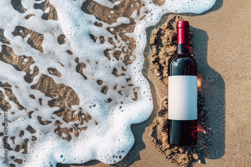 Red wine bottle mockup for brand design against a beach with waves