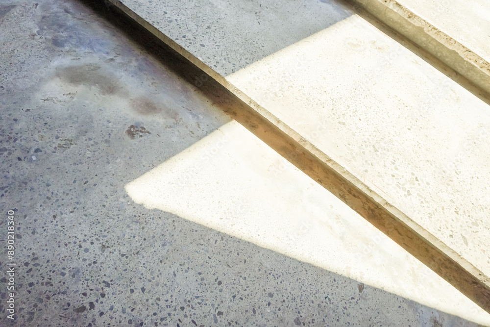 Close up photo of gray cement steps with contrast exposure of shadow and sunlight. Concrete staircase. Abstract background. Close up photo of gray cement steps with contrast exposure of shadow and sunlight. Concrete staircase. Abstract background.