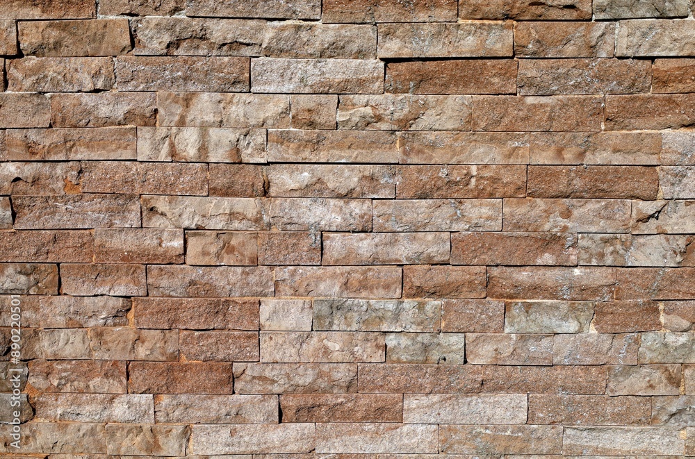 Old external stone wall made of brown limestone bricks. Background and texture. Full frame. Old external stone wall made of brown limestone bricks. Background and texture. Full frame.