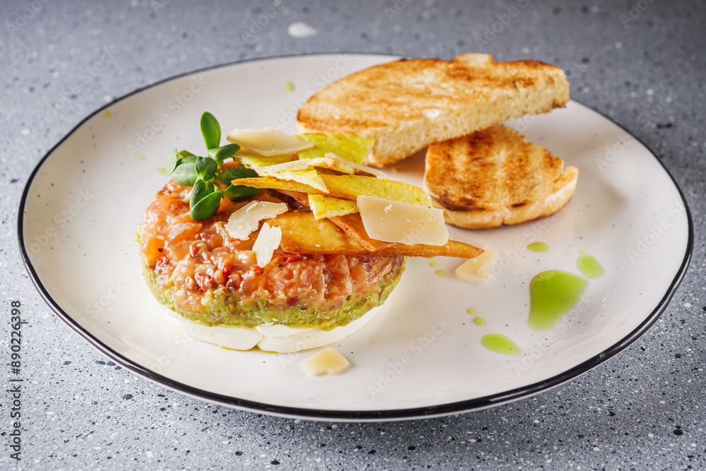 delicious fresh salmon tartar on a white plate delicious fresh salmon tartar on a white plate
