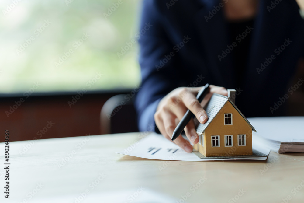 Property investment concept, Real estate broker with home insurance policy about house contract Property investment concept, Real estate broker with home insurance policy about house contract