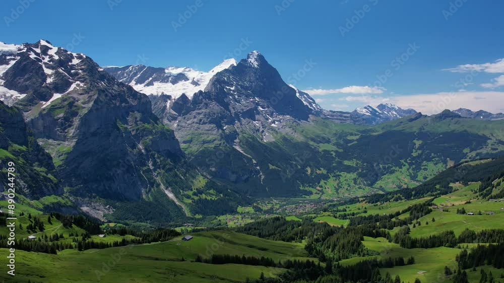 Cinematic drone fly over snow mountain and green meadows of tourist resort Grindelwald valley in Switzerland Bernese Alps. Travel and healthy lifestyle Cinematic drone fly over snow mountain and green meadows of tourist resort Grindelwald valley in Switzerland Bernese Alps. Travel and healthy lifestyle