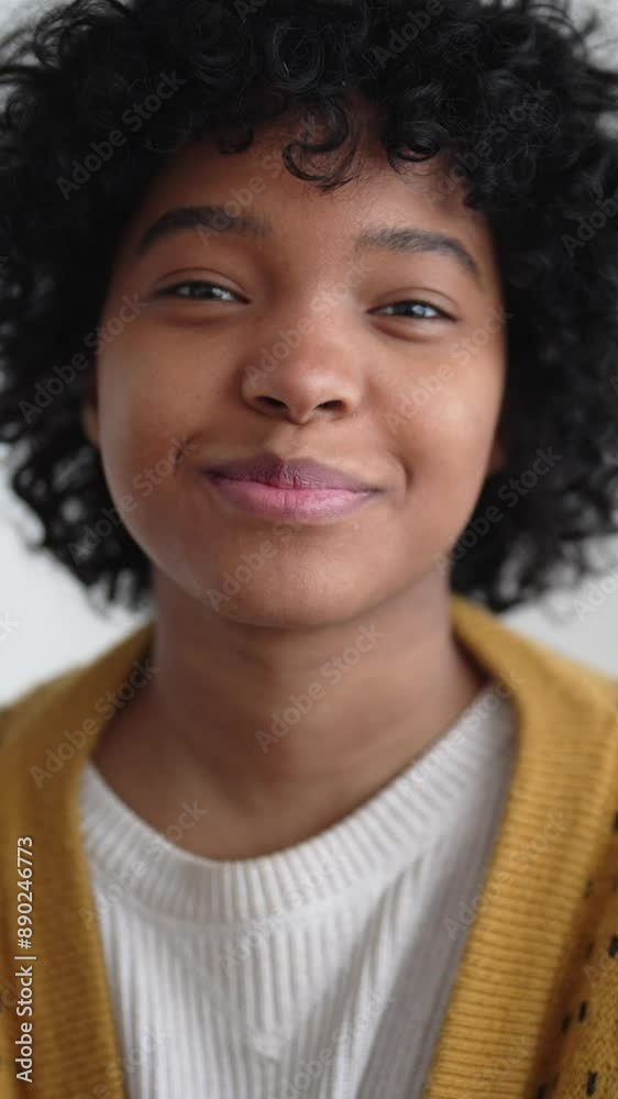 Happy African American teenager smiling broadly and looking at camera, vertical video, slow motion. Teen girl has positive emotions and good mood, happiness and joy, adolescent with health teeth Happy African American teenager smiling broadly and looking at camera, vertical video, slow motion. Teen girl has positive emotions and good mood, happiness and joy, adolescent with health teeth