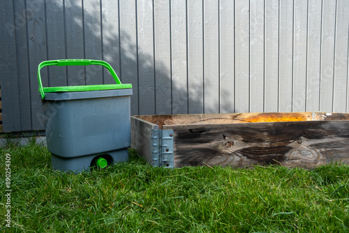 Bokashi bucket on the lawn with pallet for composting foodscraps to nutrient soil with bio char