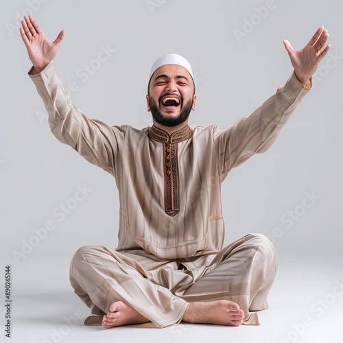 Smiling Man Wearing Traditional Clothing Raises Hands In Celebration photo