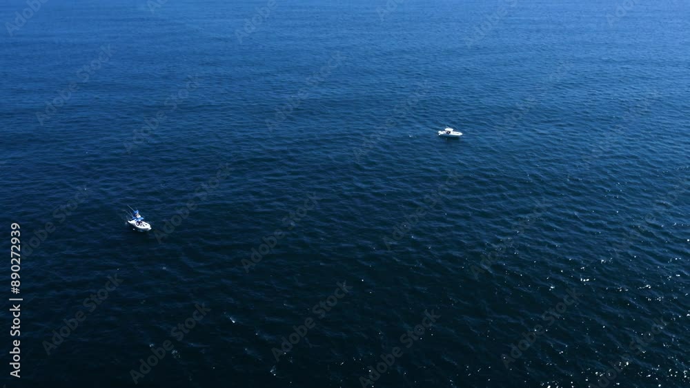 two boats sail peacefully. A moment of solitude on the water. two boats sail peacefully. A moment of solitude on the water.