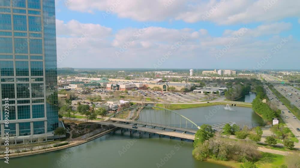 Push in establishing aerial shot of the Woodlands bridge next to the Allison Tower toward the Woodlands mall. Drone shot of the Woodlands bridge next to the interstate 45 Push in establishing aerial shot of the Woodlands bridge next to the Allison Tower toward the Woodlands mall. Drone shot of the Woodlands bridge next to the interstate 45