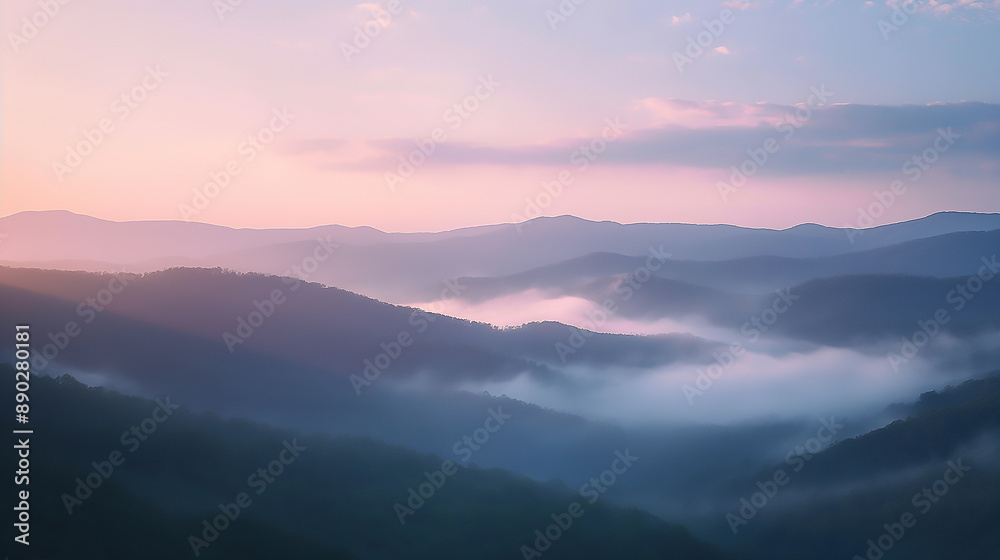 Sunrise over misty mountains with a forested valley and a sky filled with clouds Sunrise over misty mountains with a forested valley and a sky filled with clouds