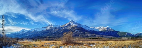 A peaceful mountain scene with a clear blue sky and snow-capped peaks, capturing the beauty and tranquility of nature.