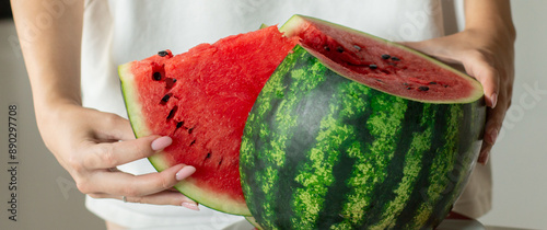 Woman slice fresh watermelon at kitchen, closeup