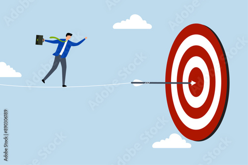 Challenge to overcome difficulty and achieve business target, businessman acrobat walk on rope to reach bullseye dart target.