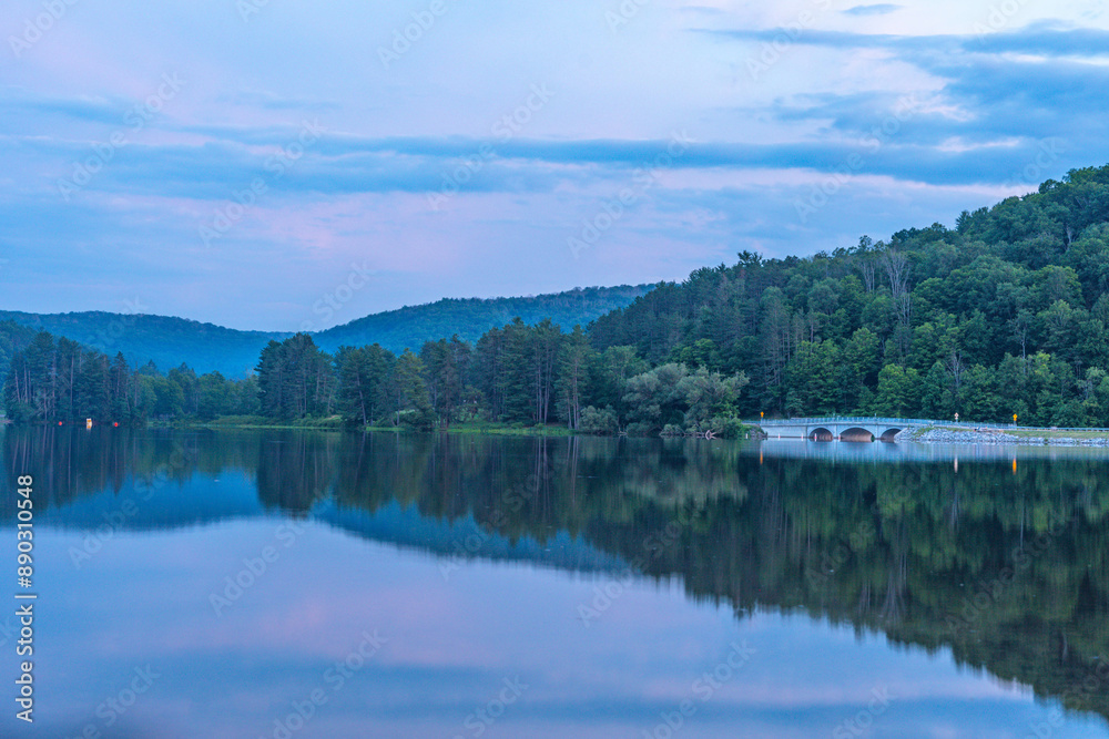 Setting sun low light long exposure over mountain lake summer season background image Setting sun low light long exposure over mountain lake summer season background image