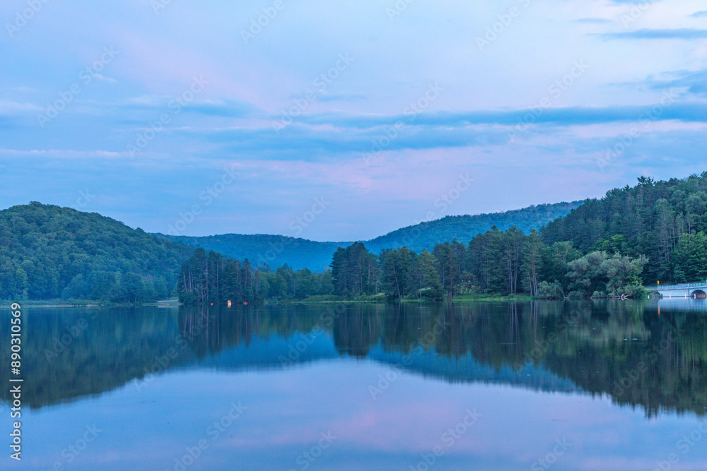 Fototapeta premium Setting sun low light long exposure over mountain lake summer season background image